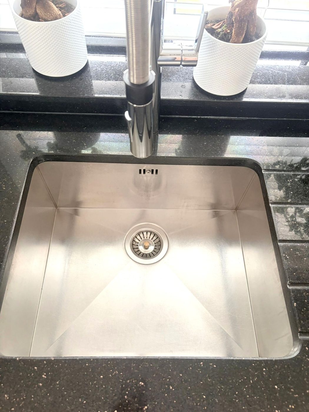 A gleaming, polished kitchen sink